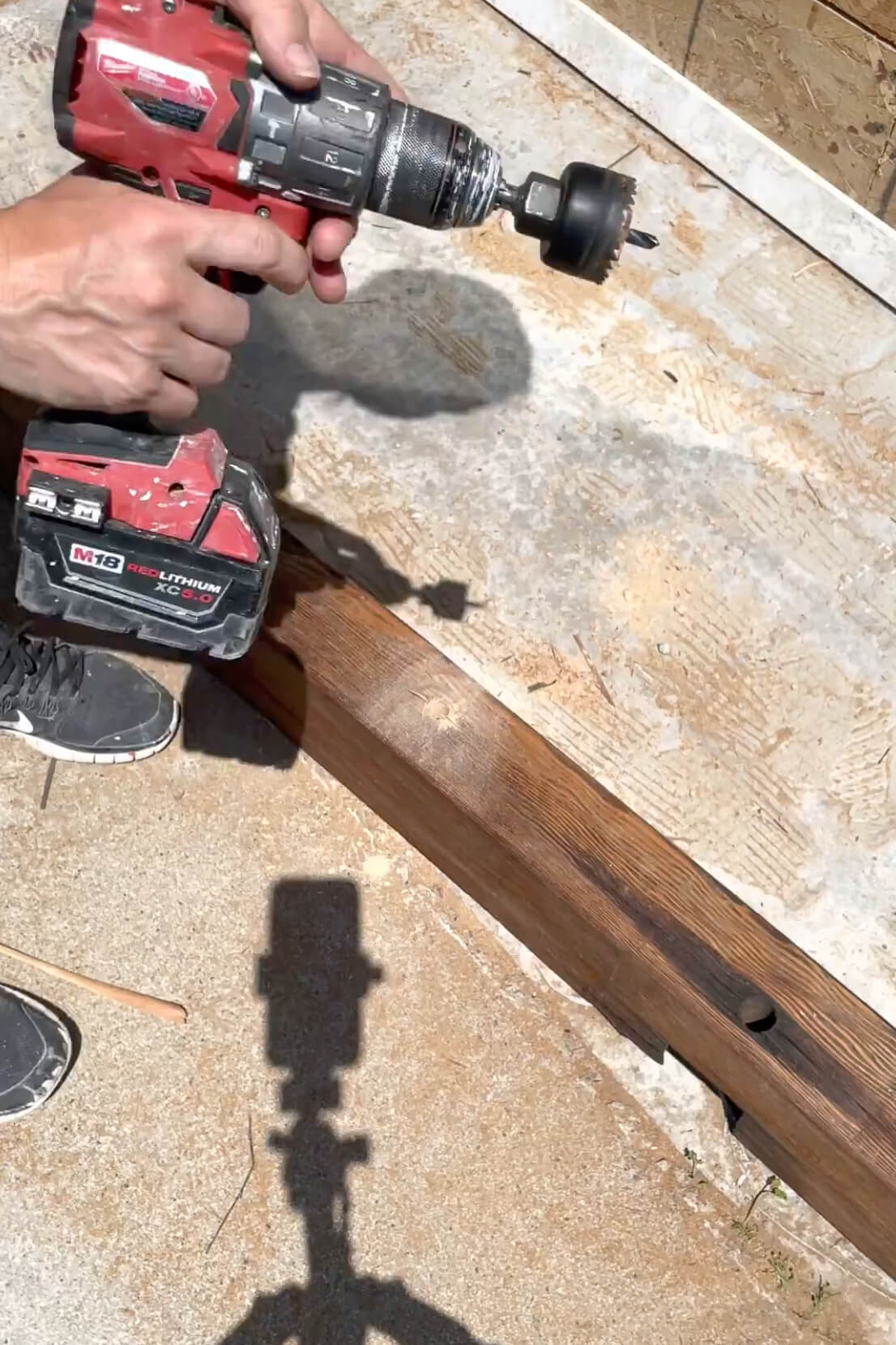 Drilling holes for mounting mantle to fireplace surround.